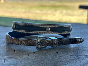 Light Brindle cowhide behind dark brown and Cross Conchos